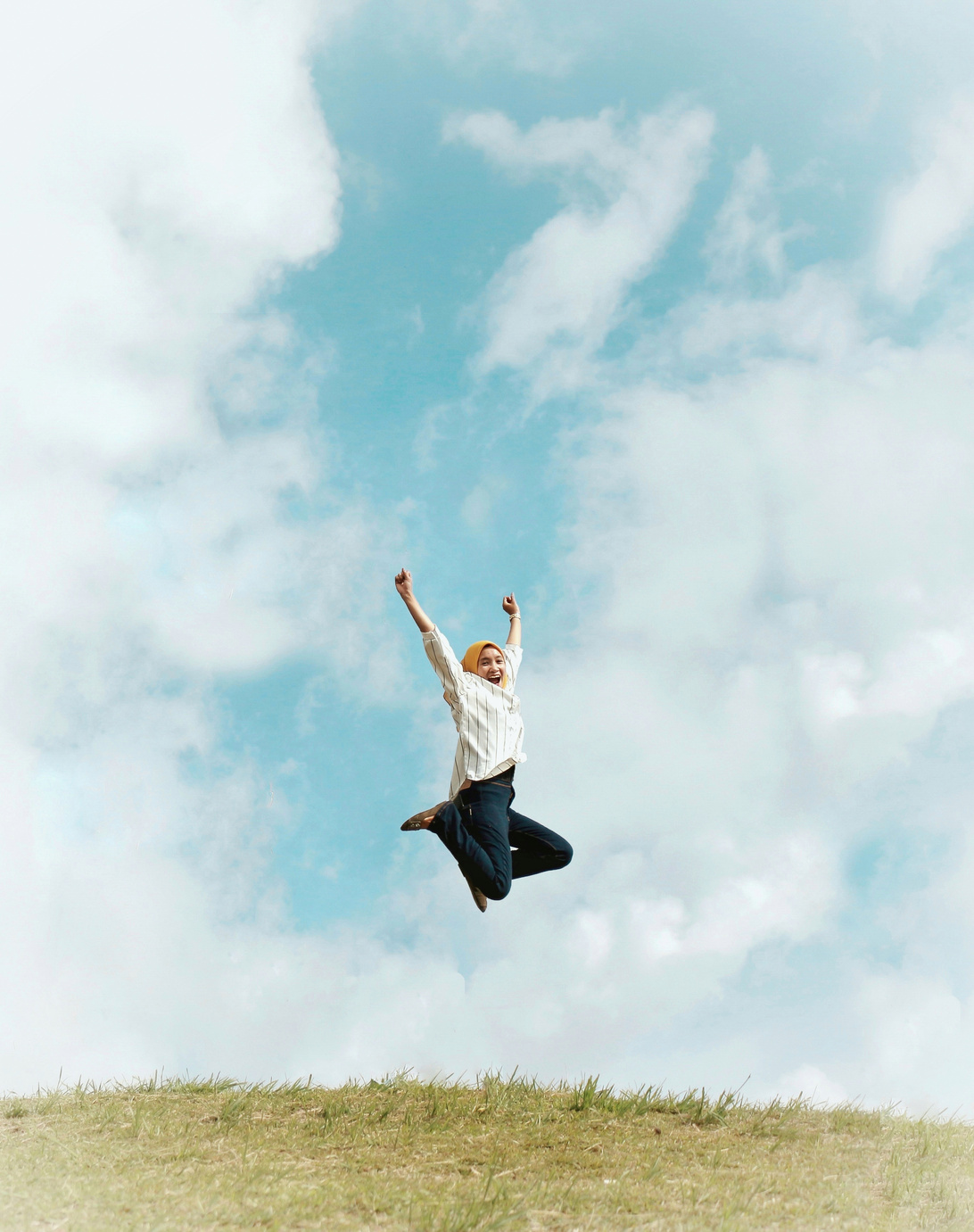 Person Jumping On Air With Clouds Background